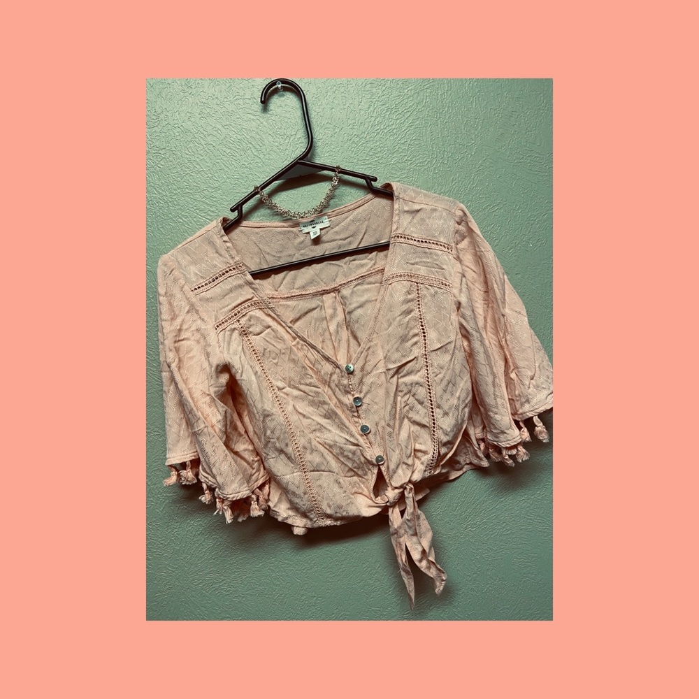 Peach colored loose button top with tassels